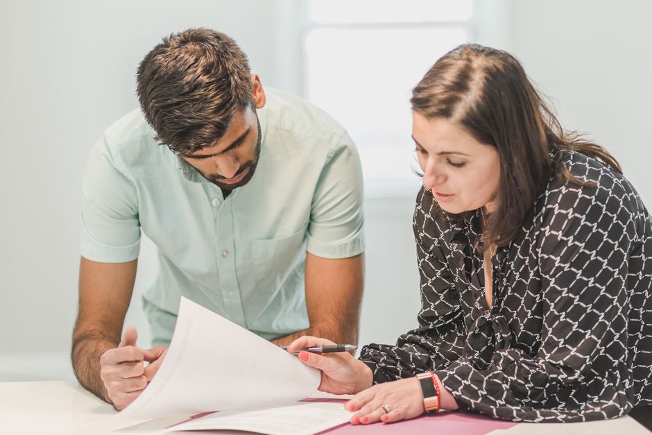Someone discussing documents with an adviser